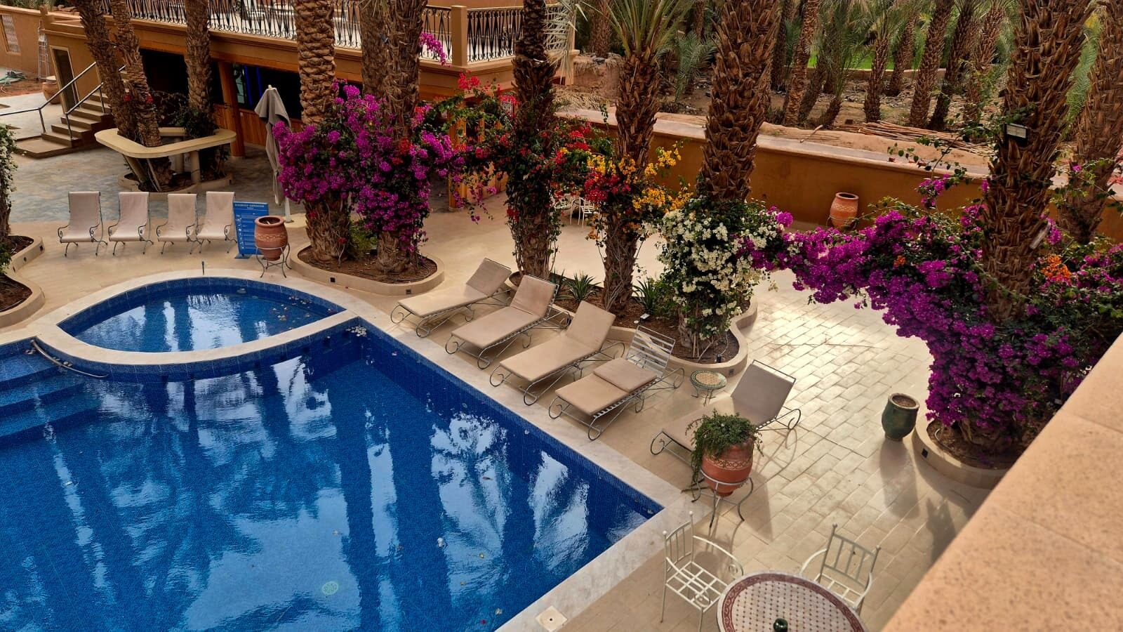 Hotel courtyard with a swimming pool and bougainvillea